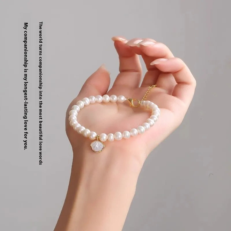 Freshwater pearl bracelet for women showing elastic and chain fastening options with fan-shaped alloy clasp