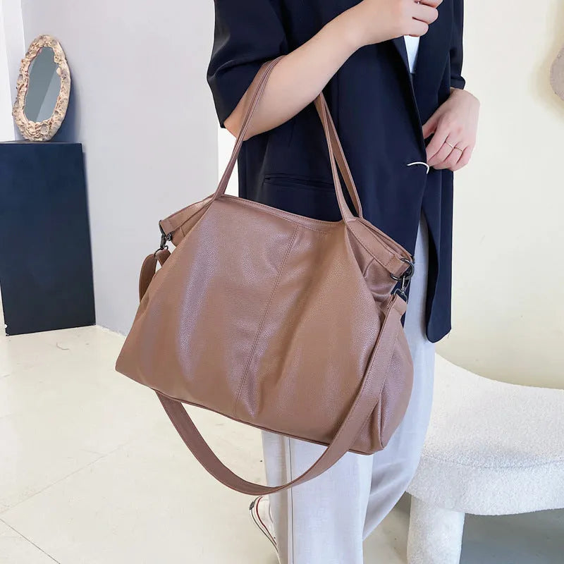 Large soft white PU messenger bag with a long cross-body shoulder strap and zip closure
