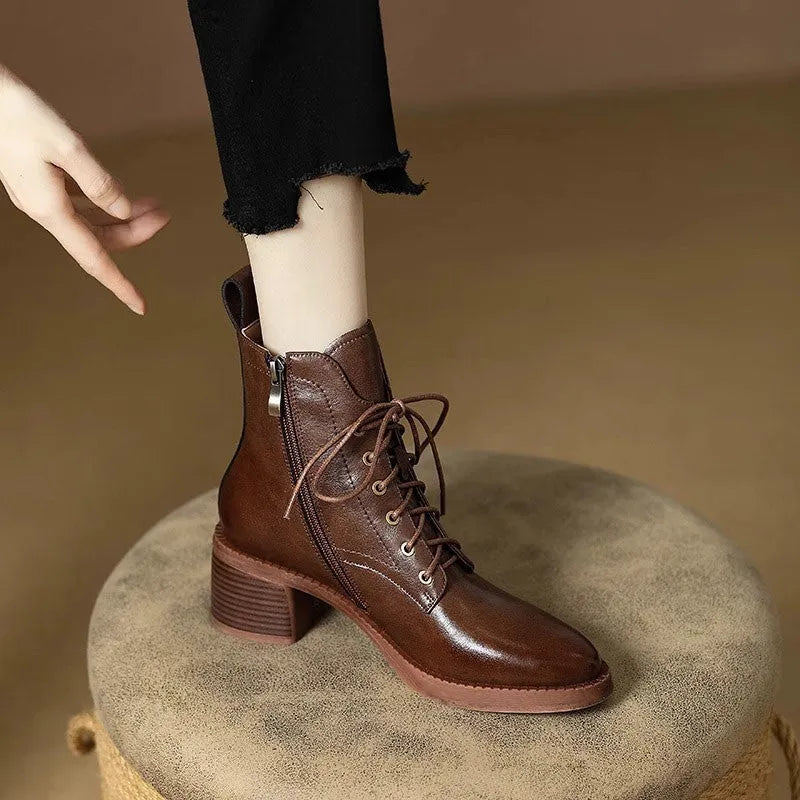 Black pointed-toe women's short tube ankle boots with a 5.5cm heel on a white background.