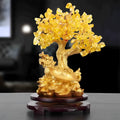 Citrine-coloured resin Feng Shui ornament of a water turtle with a money tree.