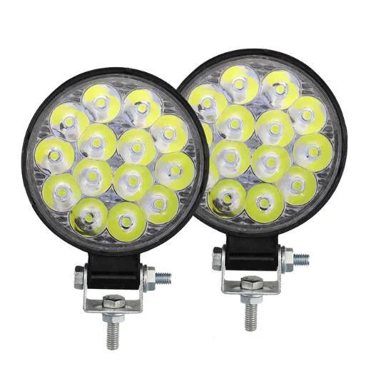 White aluminium LED work light with a round design, suitable for mounting on a vehicle.