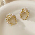 Gold-coloured copper flower basket earrings with small pearl-inlaid beads.