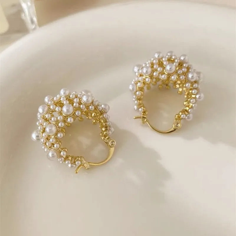 Gold-coloured copper flower basket earrings with small pearl-inlaid beads.