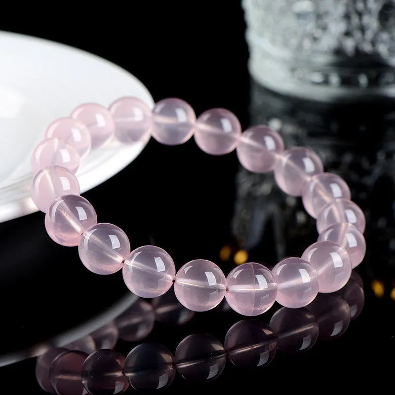 Polished natural crystal bracelet with round beads in pink colour, available in multiple bead diameters