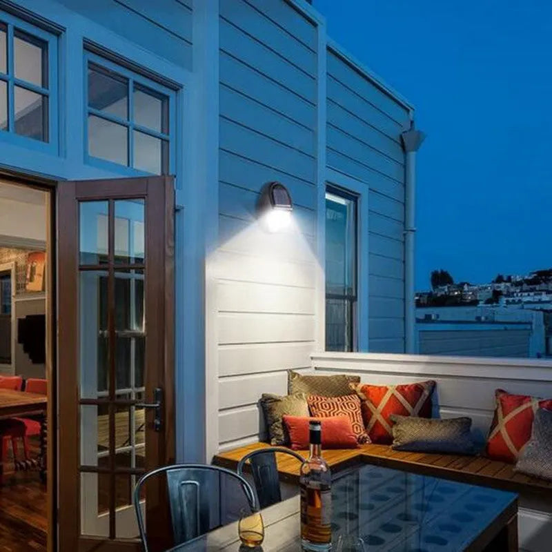Black rectangular LED solar wall light mounted on an outdoor surface