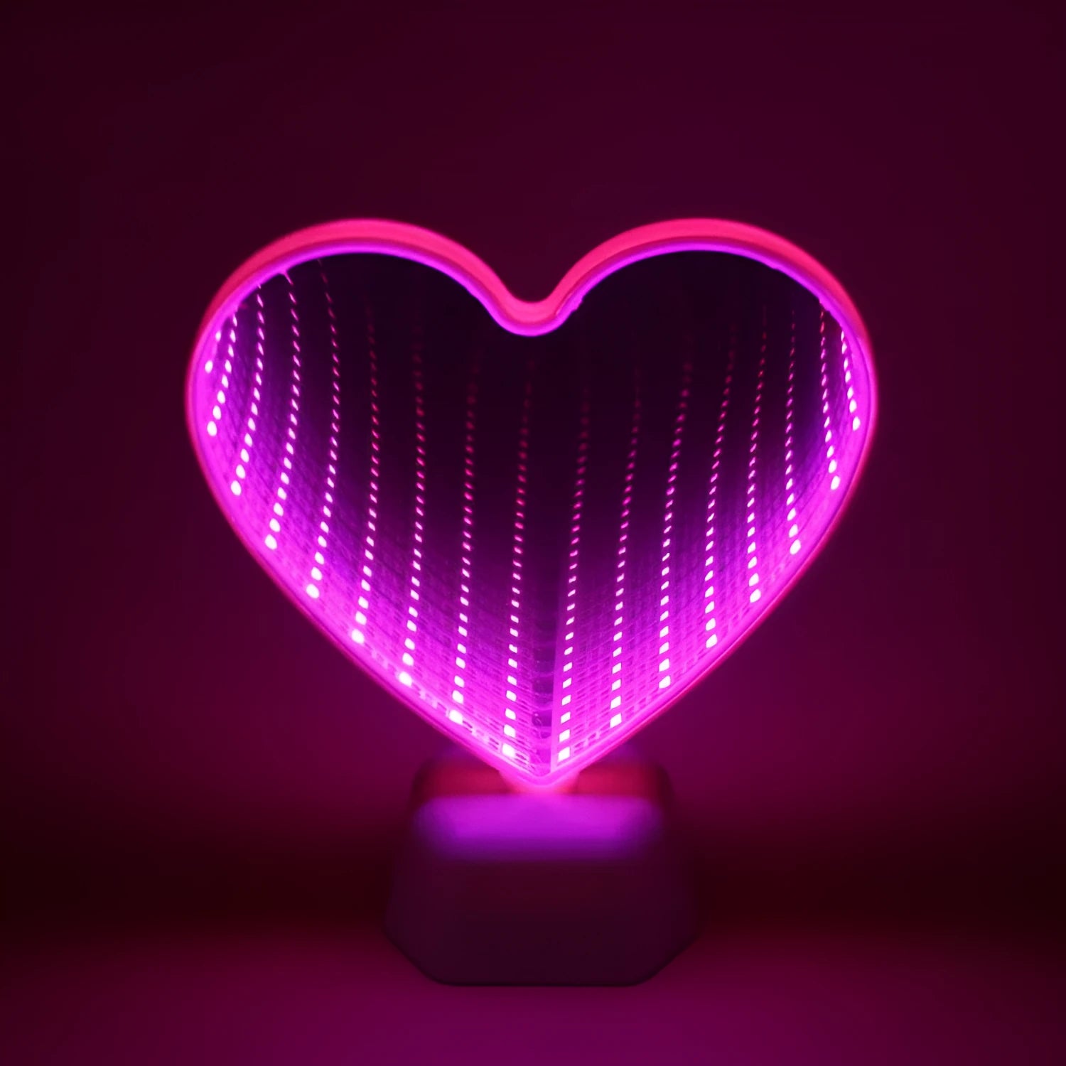 Rose red double-sided love tunnel shape LED decorative light on a flat surface.