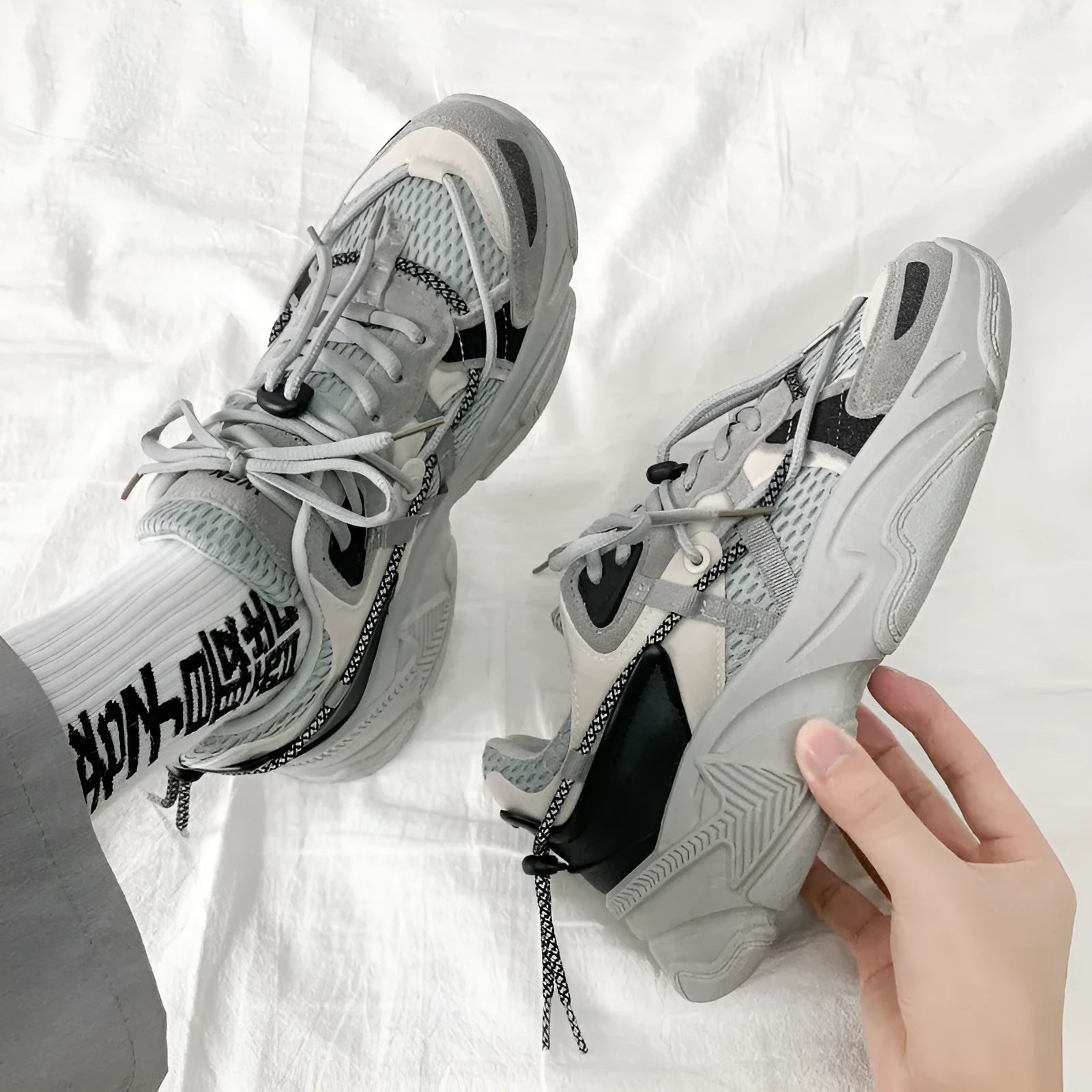 Men's white platform dad shoes in Korean style with front lace-up and mesh lining.