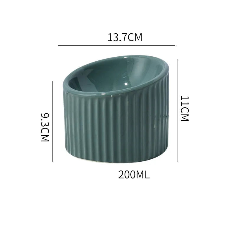 Round ceramic elevated cat bowl in green colour on a table