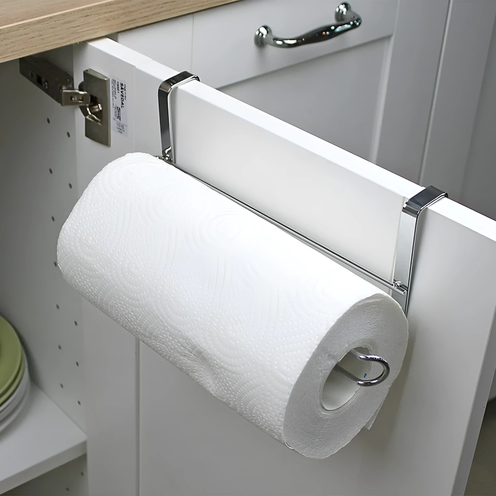 Silver stainless steel kitchen towel rack mounted on cabinet door for paper and towel storage