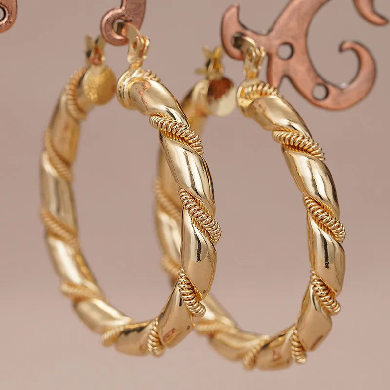 Geometric women's copper earrings with ring and line elements in golden colour