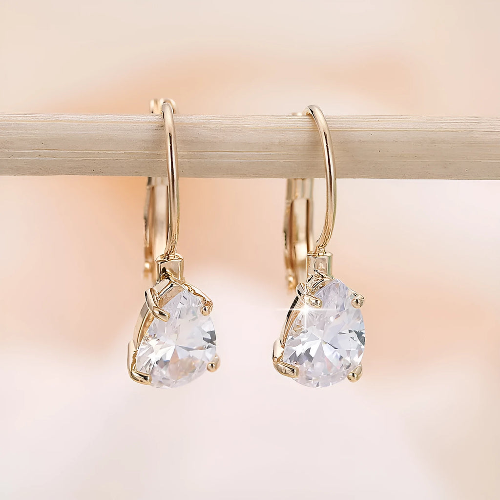 A pair of women's drop-shaped copper earrings with gemstone inlay, shown in gold and platinum colour options.