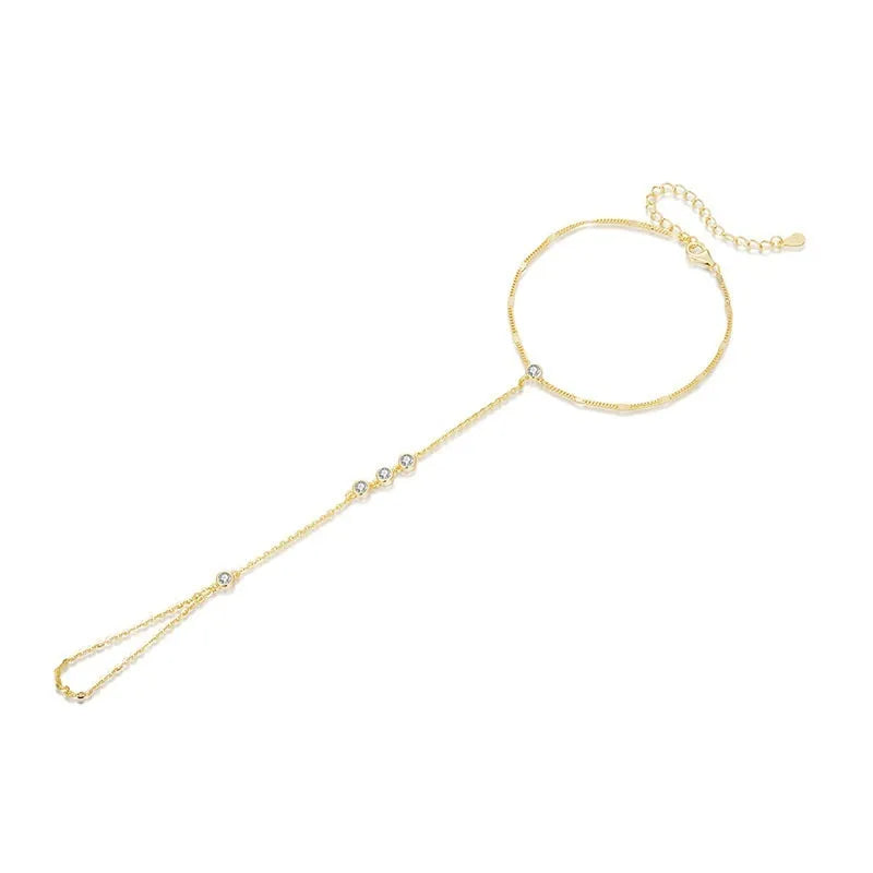S925 sterling silver tassel bracelet with integrated ring and chain, shown in silver or gold electroplated finish