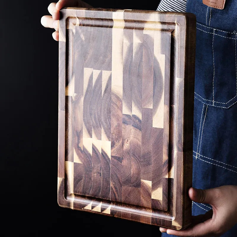 Brown solid wood chopping board with parquet pattern, shown on a kitchen countertop.