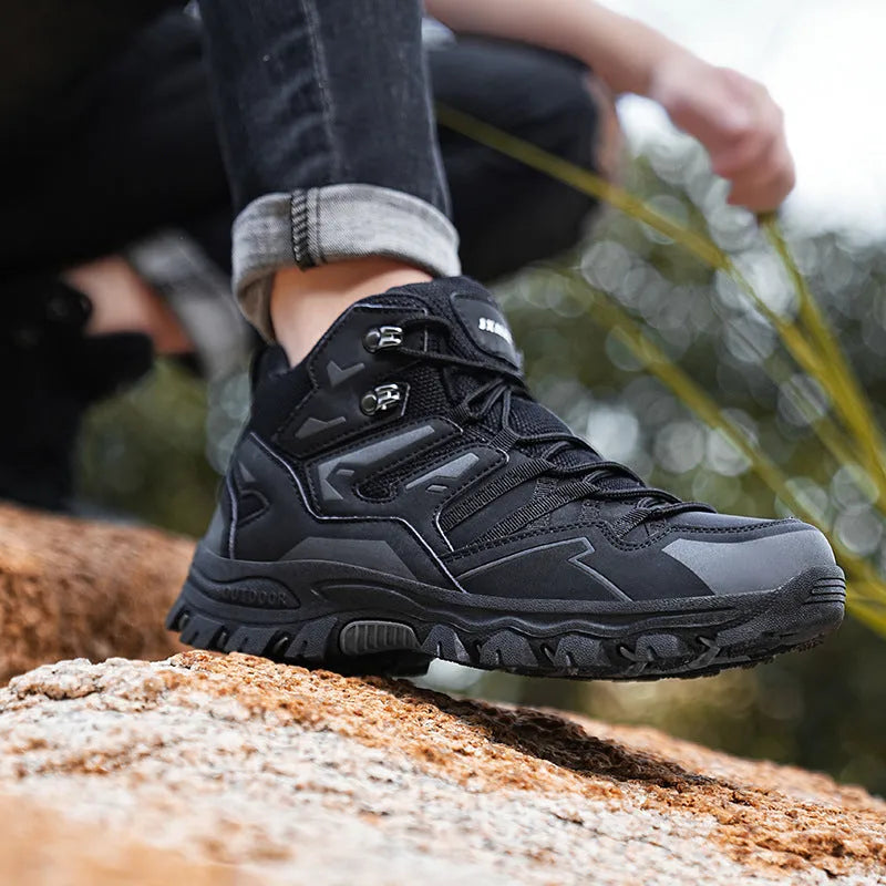 High-top outdoor hiking sneaker in flannel with rubber sole, shown on a rocky trail.