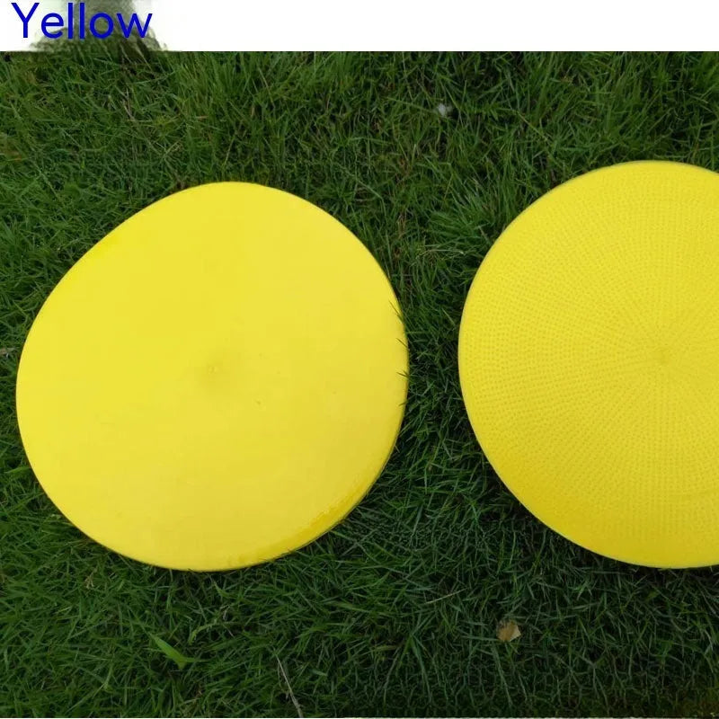 Soft coloured football training marker disc on grass field for target practice