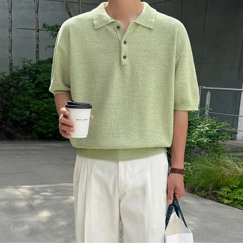Man wearing a caramel coloured loose fit knitted polo shirt with short sleeves and an asymmetric design.