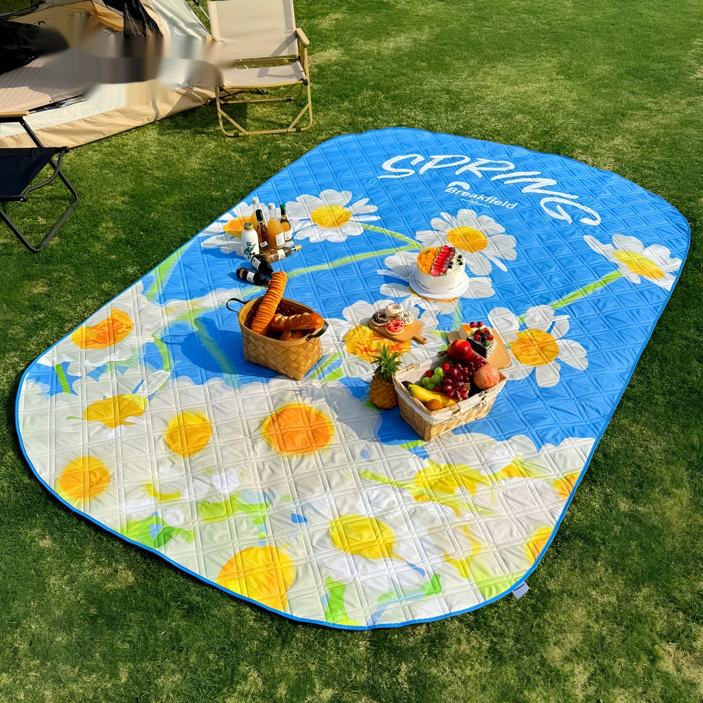 A large waterproof camping mat in a brushed fabric, shown unfolded on grass.