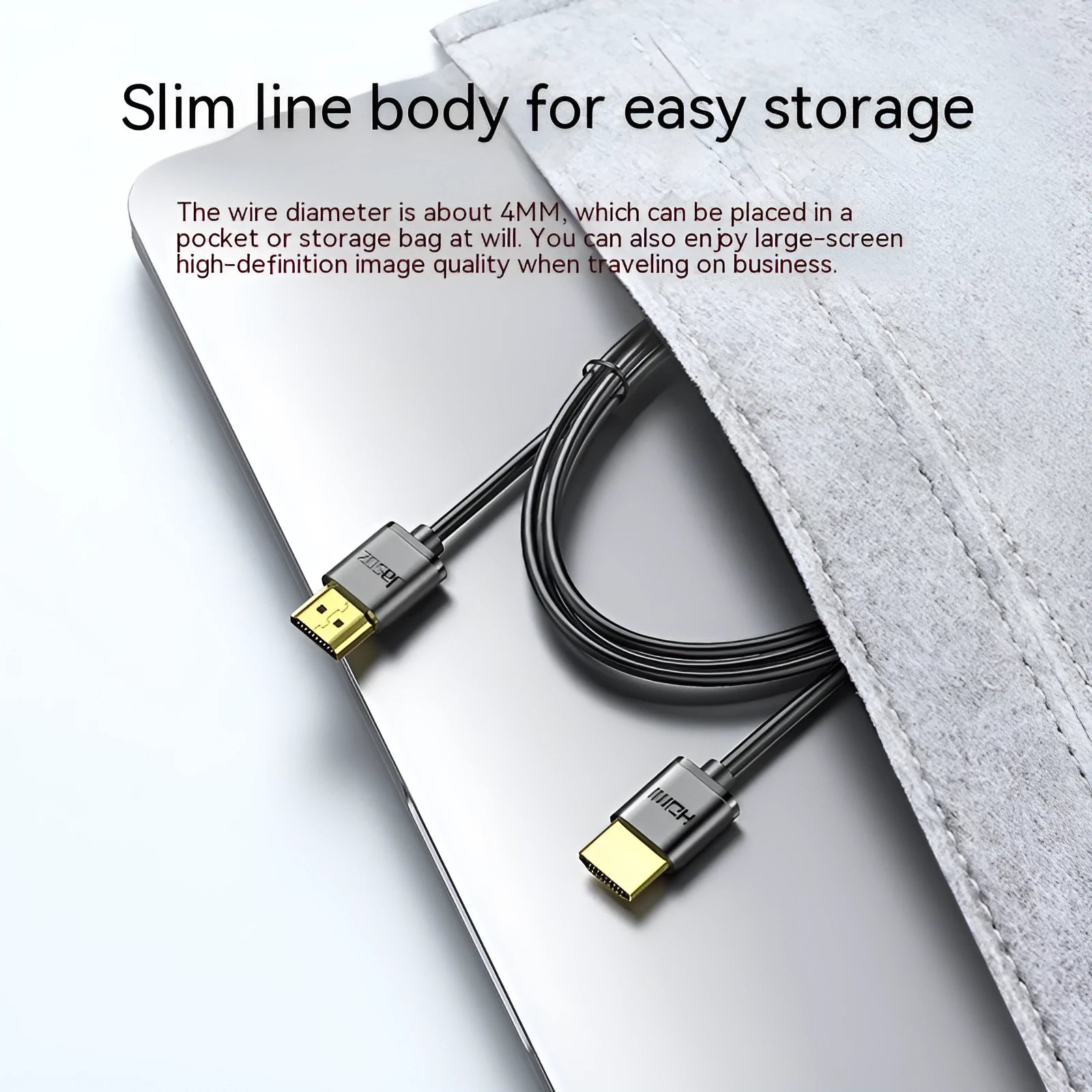 Close-up of a black HDMI cable with gold-plated connectors and a flexible cord on a grey background.