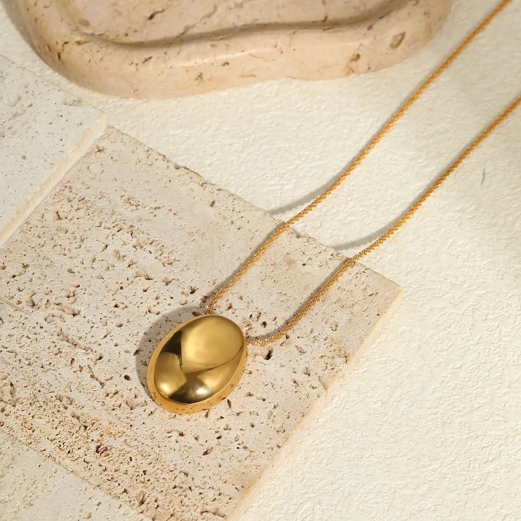 Gold geometric pendant necklace on adjustable stainless steel chain, shown at 41cm length.