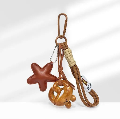 Handmade soda bread style resin handbag pendant on a brown 30 cm strap.