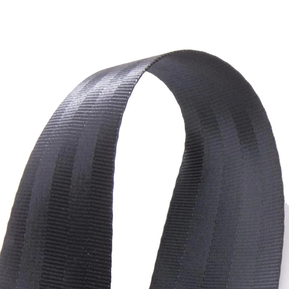 Black polyester pregnancy seat belt extender with double aircraft buckle installed on a car seat