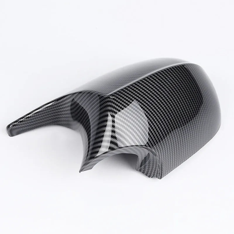 A pair of black ABS plastic rearview mirror shells for a BMW 3 Series E90 car.