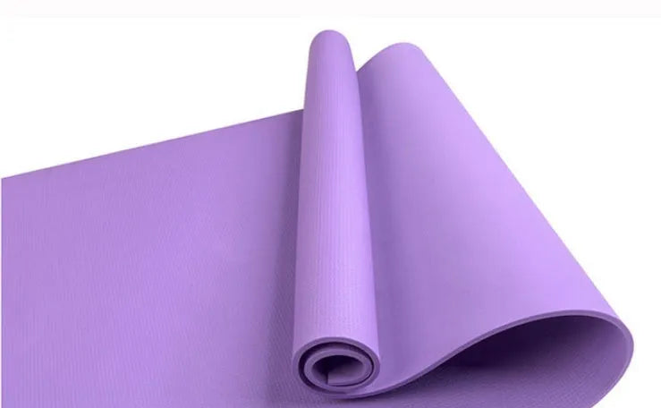 EVA foam yoga mat in blue, showing textured anti-slip surface, with a black OPP storage bag beside it.