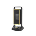 Black PTC ceramic desktop air heater with control knob on a wooden table.