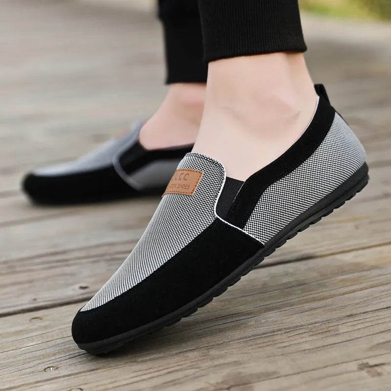 Men's grey canvas board shoes with round toe and rubber sole on a white background.