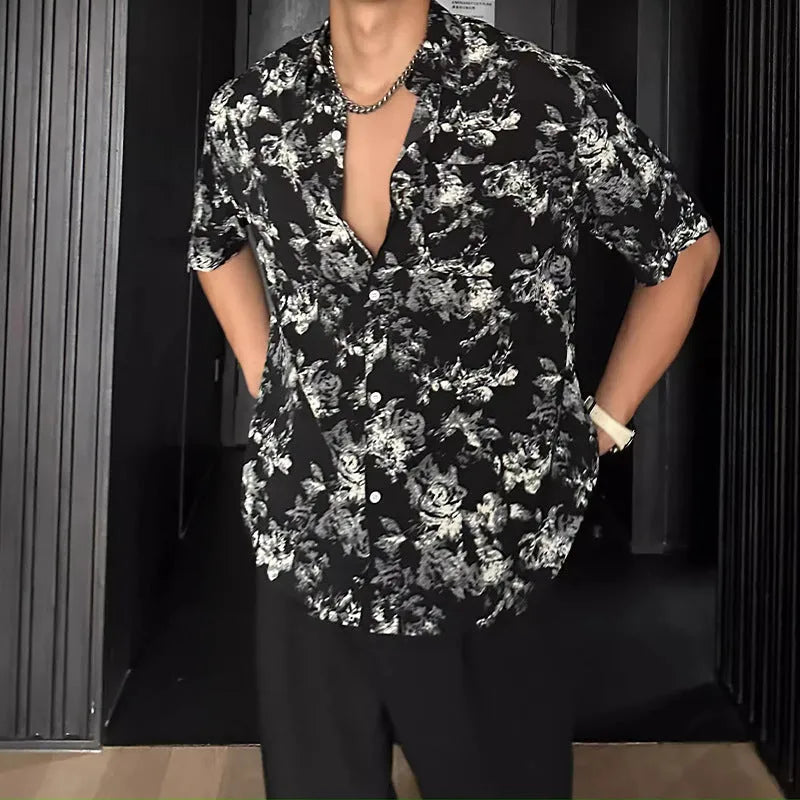 Loose black floral print short sleeve casual shirt on a hanger.