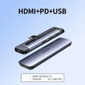 USB-C expansion dock adapter with short cable, showing HDMI, USB 3.0, and Power Delivery ports.