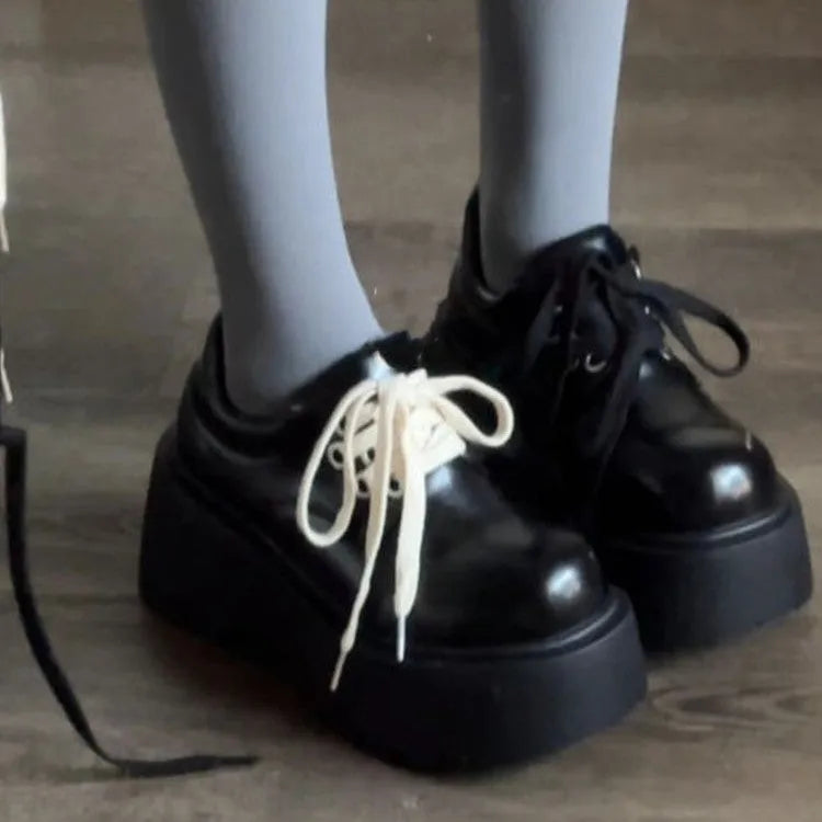 Matte black women's lace-up shoes with a chunky rubber sole and 6-8cm heel.