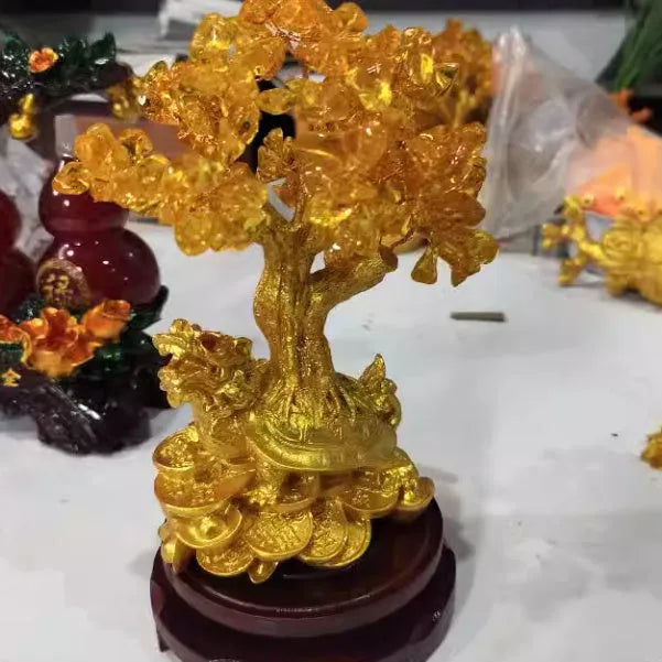 Citrine-coloured resin Feng Shui ornament of a water turtle with a money tree.