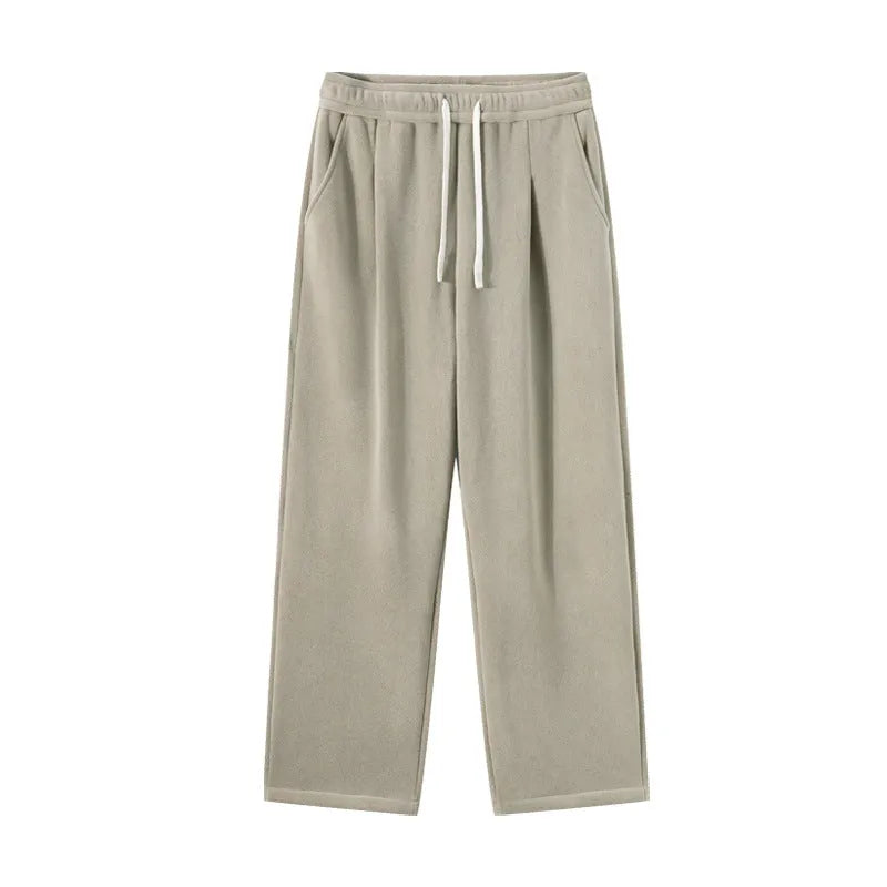 Man wearing apricot double-sided polar fleece lined loose fit casual sports trousers.