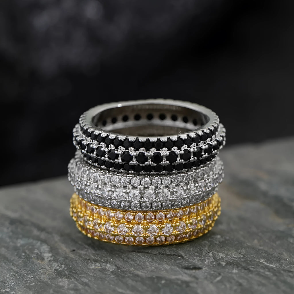 Geometric triangular zircon inlay ring in white gold finish on a finger.