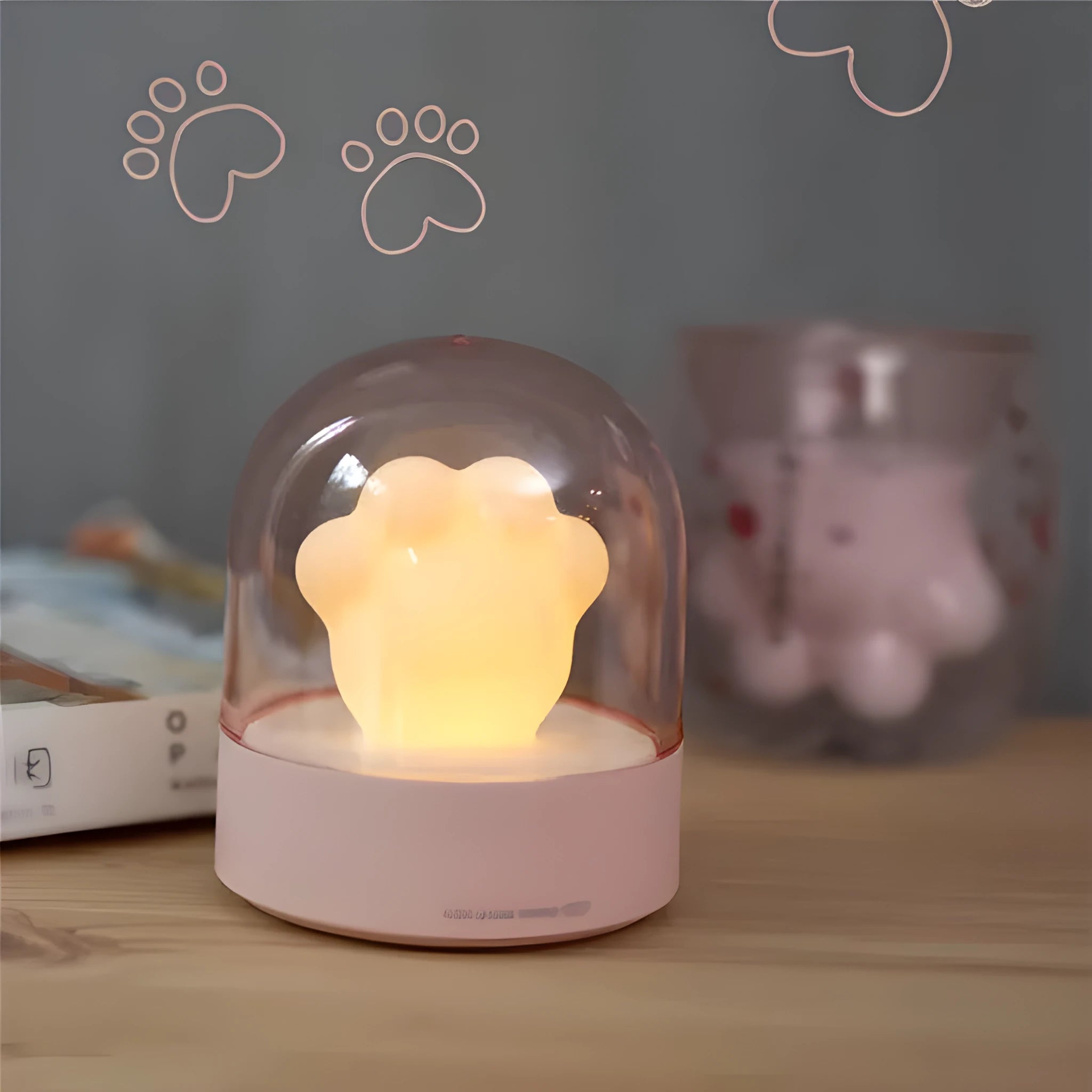 Grey cat paw shaped USB rechargeable night light with music box function on wooden desktop