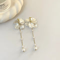 Women's silver shell pearl tassel earrings showing 8.8cm length and clip options