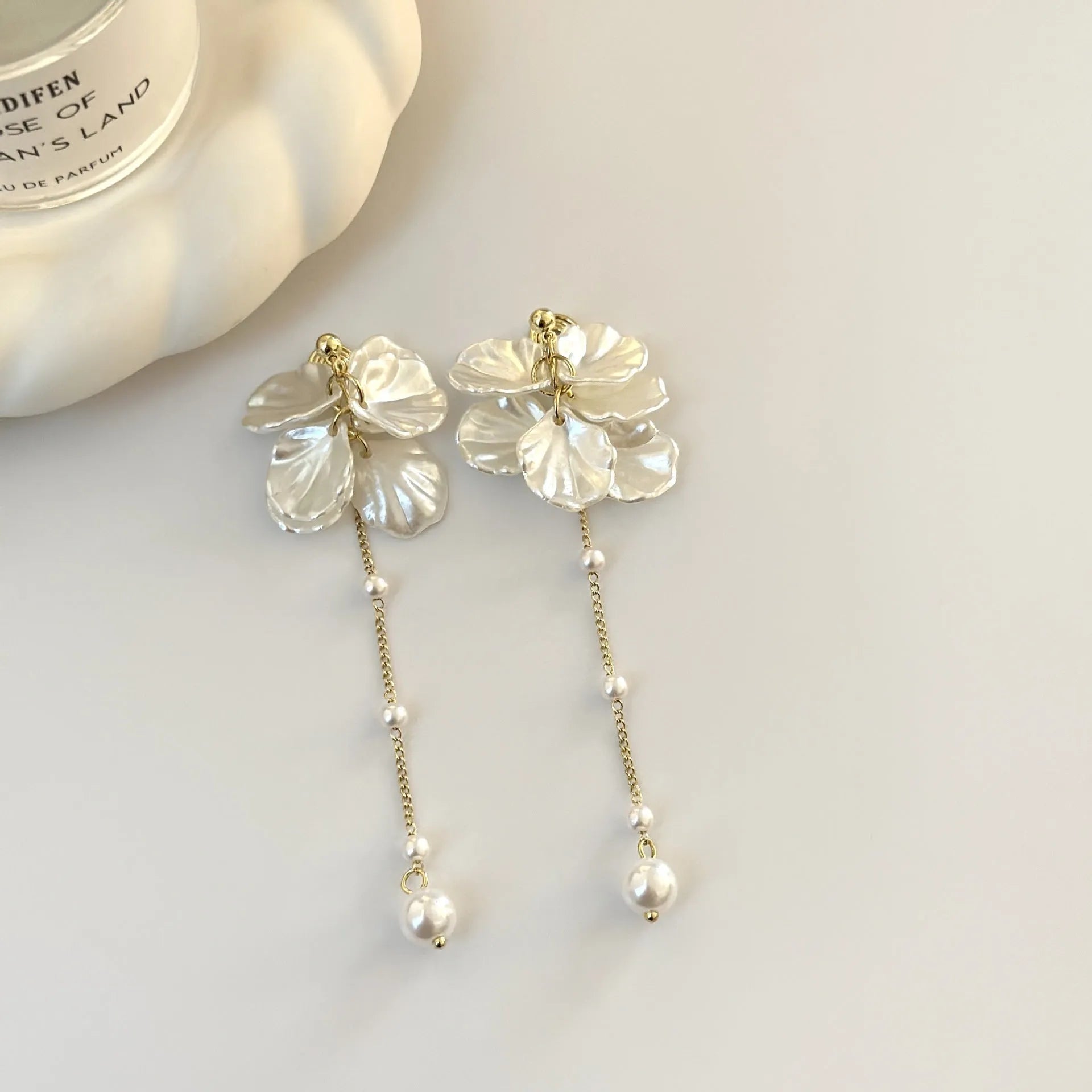 Women's silver shell pearl tassel earrings showing 8.8cm length and clip options