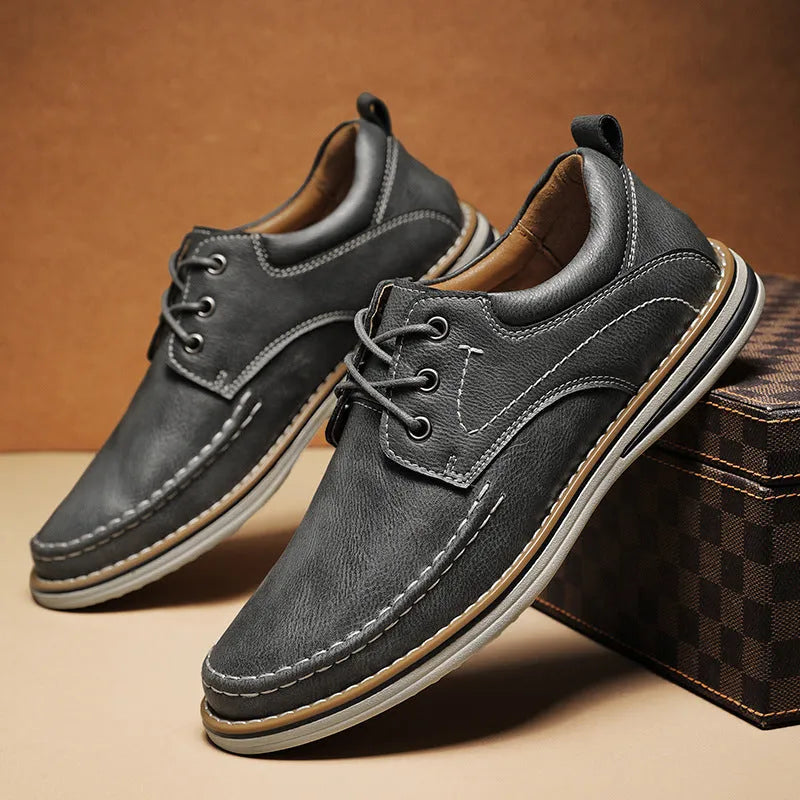 Men's genuine cowhide leather casual shoes in black with round toe and front lace-up design on a neutral background