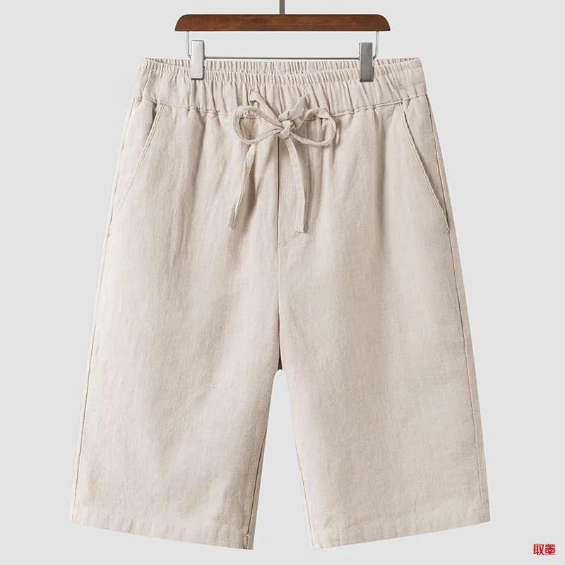 Men's beige linen loose cropped casual shorts on a neutral background.