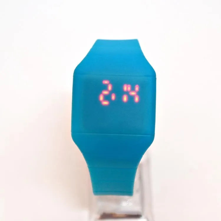 Square electronic touch screen watch with plastic case and PU strap on a wrist.