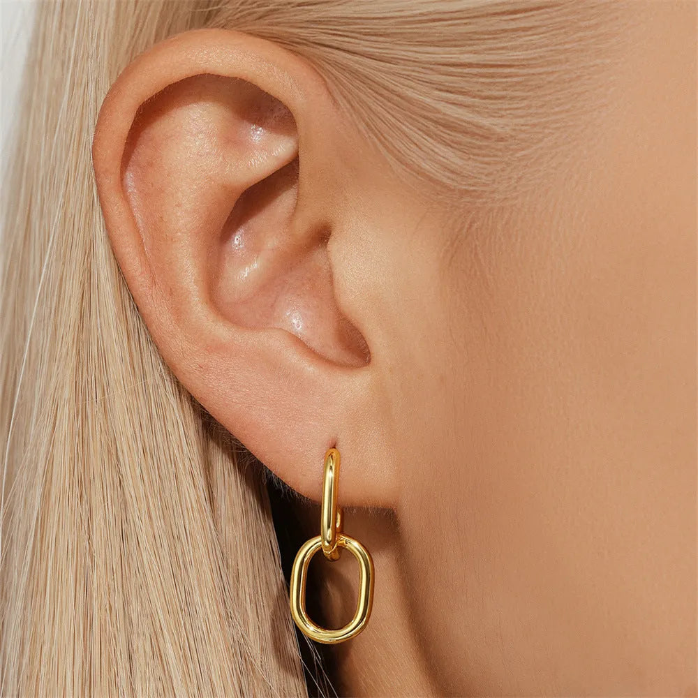 Golden brass diamond earclip earrings with geometric shape and round decorative elements