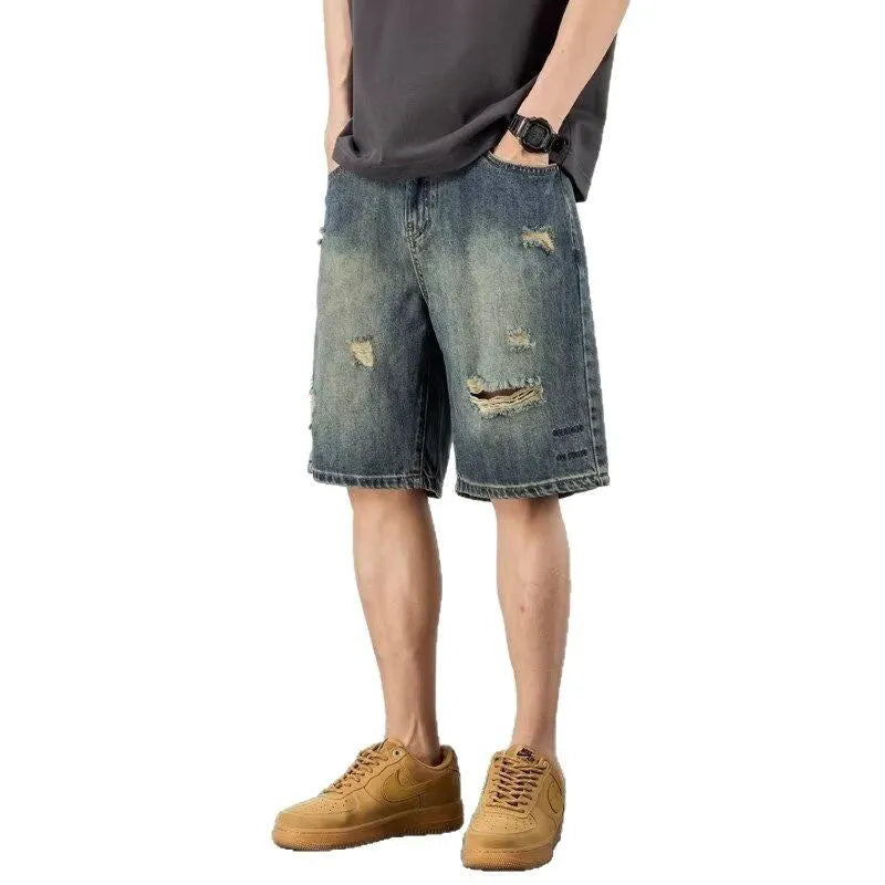 Blue distressed denim men's shorts with a loose retro fit and hole detailing