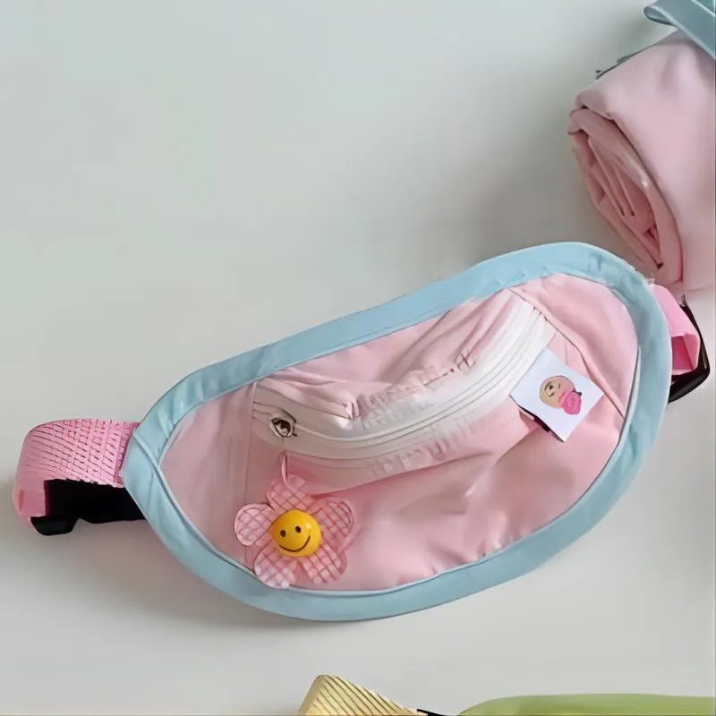 Pink adjustable backpack-style messenger bag carrier for a small dog or cat, showing the poop bag holder.