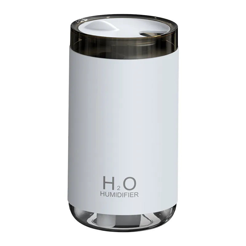 White jellyfish smoke ring humidifier with warm night light on a wooden surface