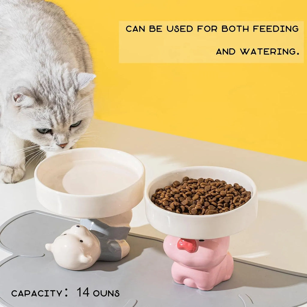 Raised ceramic cat bowl with animal design in pink, yellow, or white, showing wide rim.