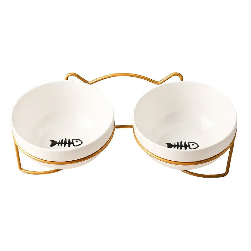 White ceramic cat bowl with paw print design in a black iron cat-ear frame.
