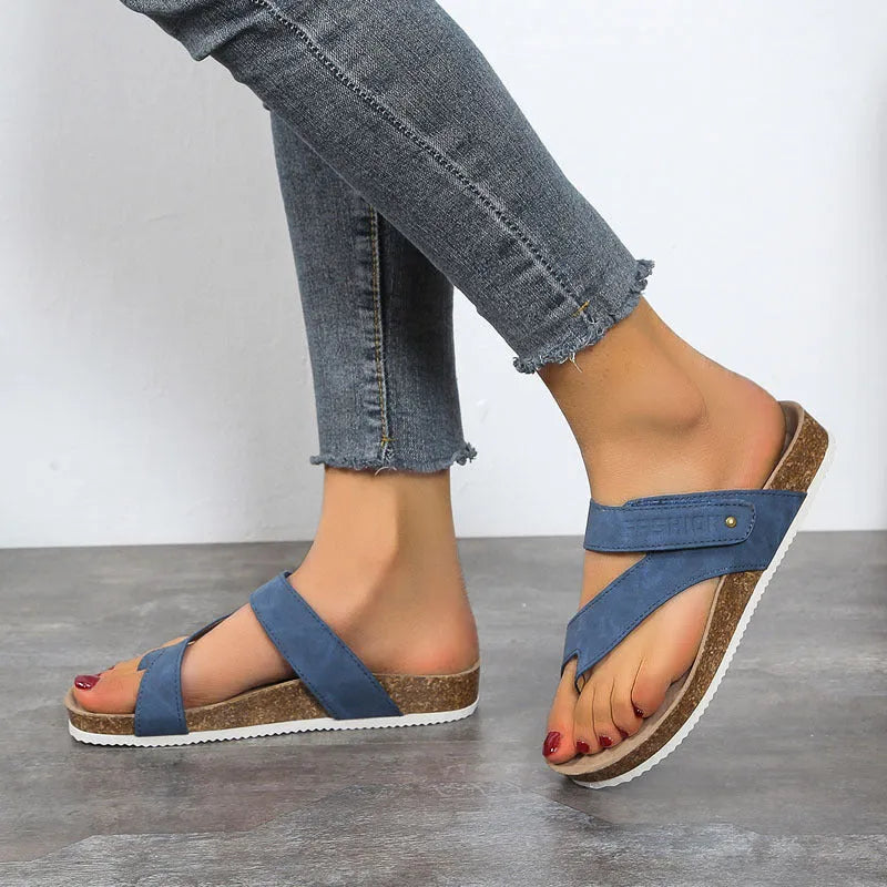 A pair of thick-soled flat toe ring flip flops in a solid colour, showing the foam sole and artificial PU upper.