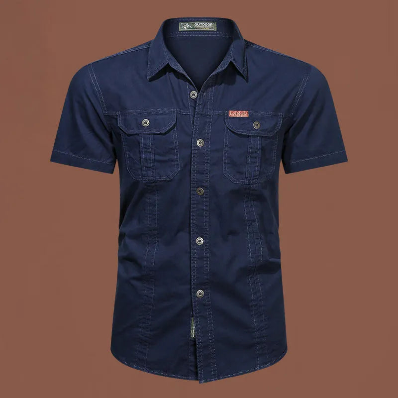 Men's army green cotton work shirt with short sleeves and non-iron finish on a hanger.