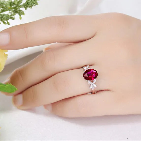 Women's rose gold plated butterfly ring with heart charm in red or blue colour options